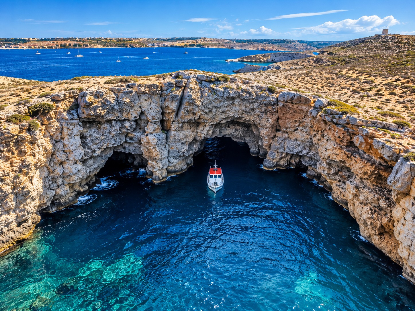 Aerial coastal grotto and boat view