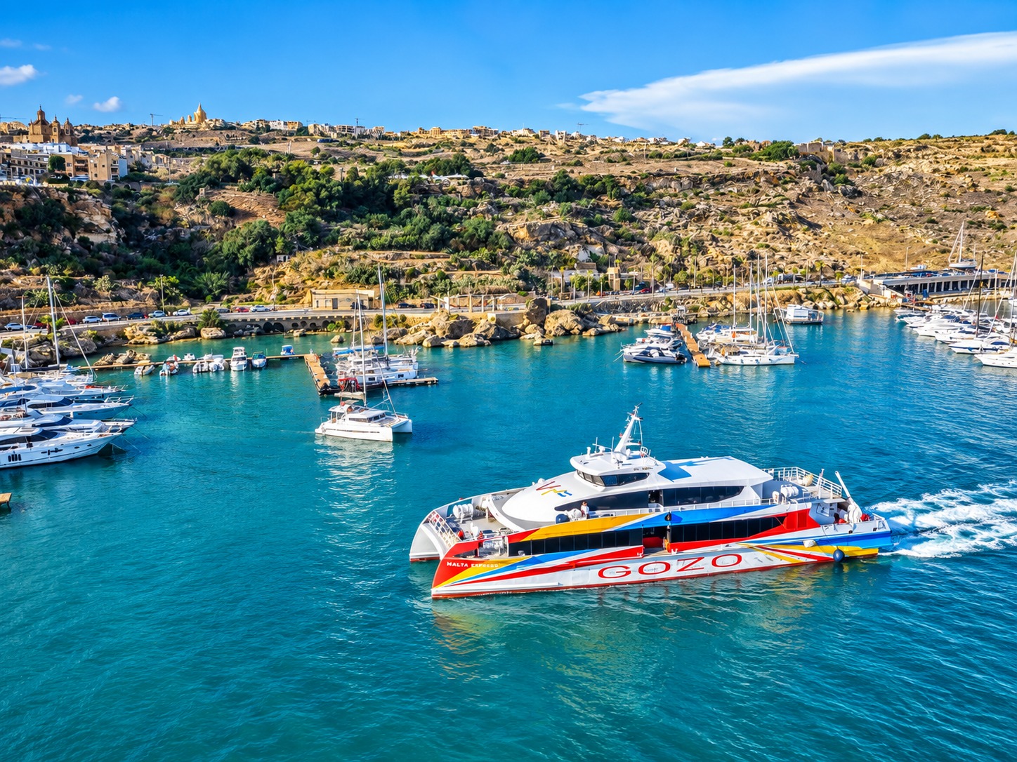 Aerial view of a passenger catamaran in Mgarr harbour